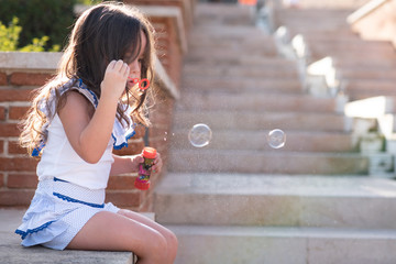 beautiful girl  Shooting Bubbles from Bubble Gun in the park