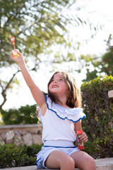 beautiful girl  Shooting Bubbles from Bubble Gun in the park