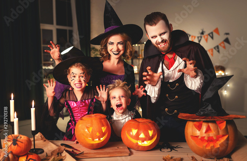 happy family mother father and children in costumes and makeup on  Halloween.