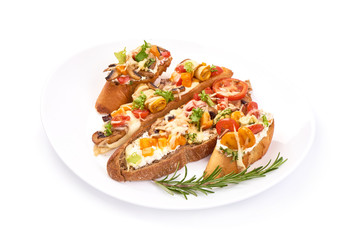 Bruschetta with cottage cheese, tomatoes, zucchini, champignon mushrooms, garlic and herbs. Spanish Tapas and Pinchos, isolated on white background