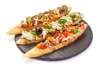 Italian Bruschetta, Spanish Tapas and Pinchos on a stone plate, isolated on white background