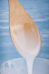 Inverted sugar syrup pouring from a spoon