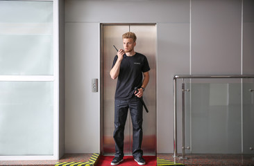 Male security guard near elevator