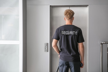 Male security guard near elevator