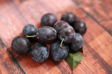 blue plums from his garden on a wooden table