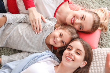 Happy lesbian couple with little daughter at home