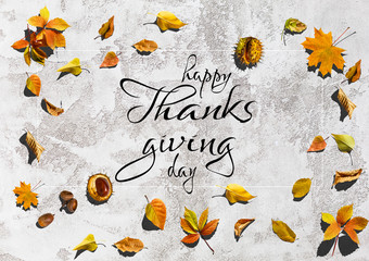 Happy Thanksgiving Day hand-lettering text. Handmade vector calligraphy on Background with Leaves
