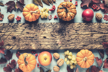 autumn background of fall leaves and pumpkins and variety harvest fruits and blank space for a...
