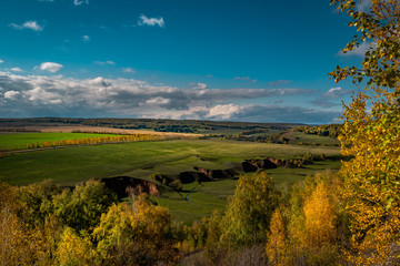 autumn landscape with river and blue sky