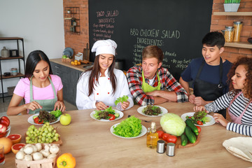Female chef and group of young people during cooking classes