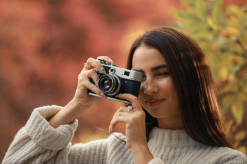 Woman photographer take a photo of the autumn nature