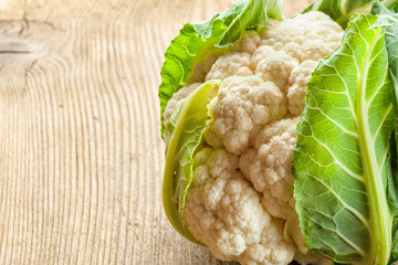 A head of cauliflower lies on a table