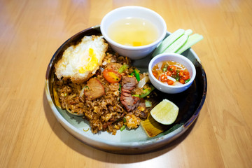 Thai local fried rice with black soy sauce (Rodfai Fried rice) with fried egg and pork sliced.