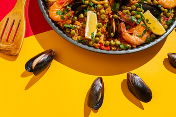 Spanish paella with seafood on the background of the Spanish flag