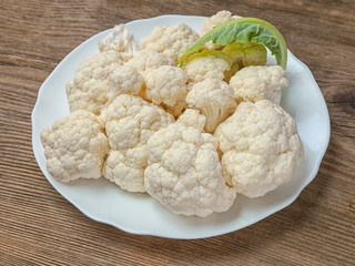 Cauliflower cut into pieces lies on the table