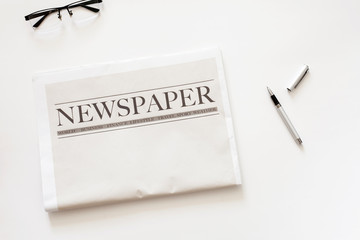 Newspaper and coffee on white background