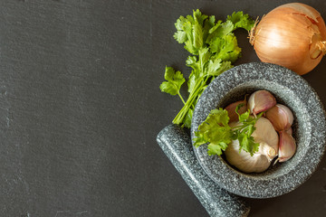 Black stone mortar for mashing garlic and parsley