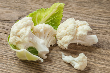 A head of cauliflower lies on a table