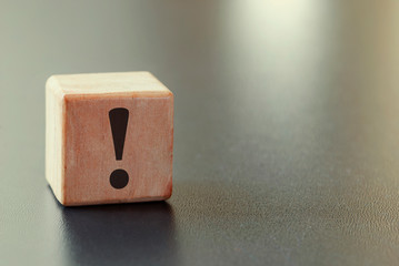 Small wooden block with exclamation mark