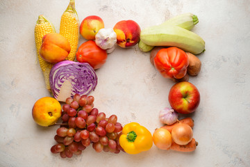 Frame made of healthy vegetables and fruits on light background