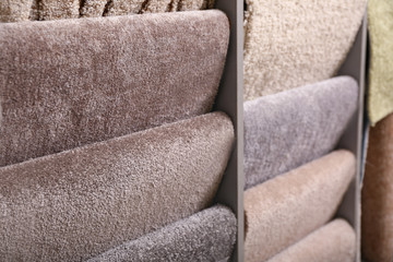Different samples of carpets in shop, closeup