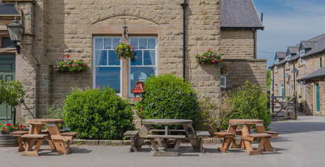 Tables and chirs in fron of a traditional pub in UK.