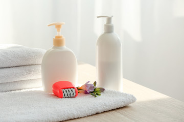 Towel, modern epilator and cosmetics on table