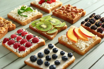 Different tasty sandwiches on wooden background