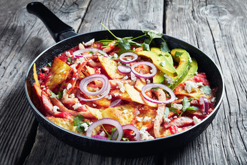 chilaquiles with ham, cheese, avocado, top view