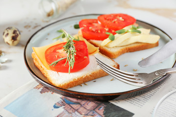 Plate with tasty sandwiches on table