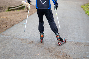 Man Cross-country skiing with roller skis in the Park