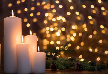Tree branches, cones, bokeh lights, candles. Preparation for the New year