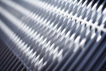 Grill of heating radiator in office, close up. White heat exchangers. Iron aluminium lattice of...