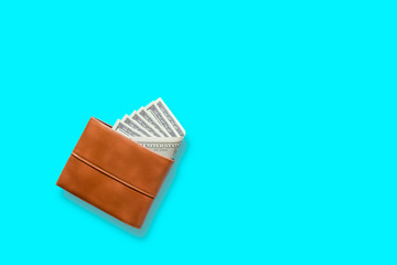 USA banknote 100 dollar type put in brown leather wallet with blue blackground