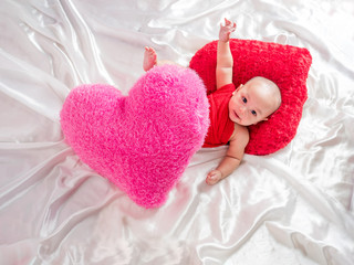 cute asian four-month baby in cupid dress smiling
