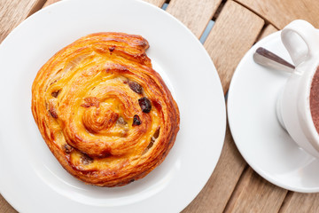 coffee and cake snail on the table in the cafe
