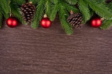 Christmas decorations with branches of fir tree, christmas ball and Pine cones on wooden background. copy space