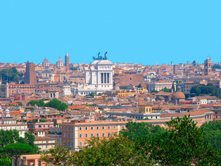 Fototapeta na wymiar Italy, Rome. Panorama of the city with a monument to Victor Emmanuel II. View of the Eternal City from the Yanikul hill. General architecture with residental buildings, churches, trees on summer day.