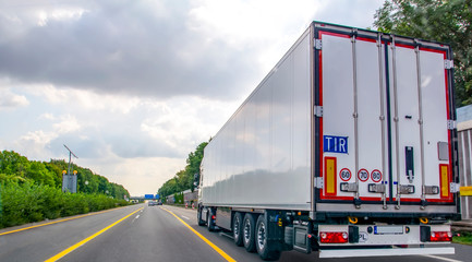 Truck with container on highway, cargo transportation concept.