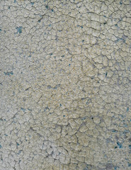 the surface of an old painted wall with badly cracked paint