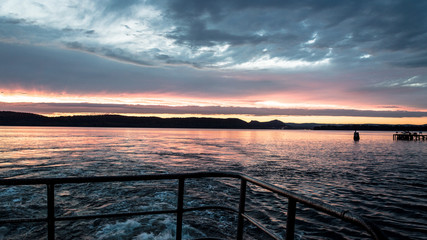 Fototapeta na wymiar Sunset on water / mountains