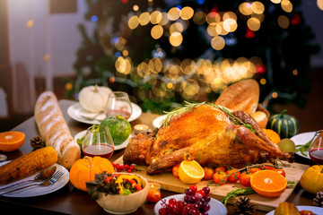 Fototapeta na wymiar Traditional Stuffed Turkey with side dishes corn bread and pumpking pie for holiday dinner Thanksgiving Roast Turkey Dinner