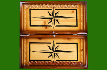 Dice and checkers on a wooden backgammon board.