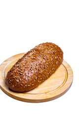 Rye bread with seeds lying on a wooden Board