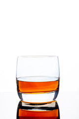 Glass of whiskey on a white background. White background. Whiskey / Brandy / Cognac / Rum. Glass with a strong drink.