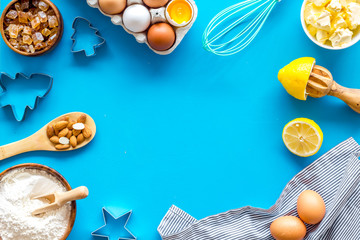 Cooking for Christmas or New Year dinner. Baking frame. Ingredients and utensil on blue background top view copy space
