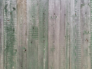 old wooden planks painted green with peeling paint