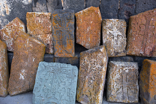 ancient slabs of old Sevanavank monastery. Armenian shrines stand against the wall in the monastery