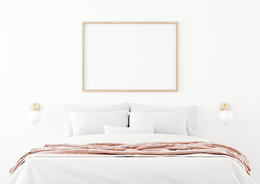 Poster mockup with horizontal wooden frame hanging on the wall in bedroom interior with unmade bed, pink plaid and bedside lamps on empty white background. 3D rendering, illustration.