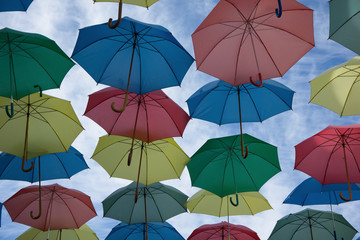Umbrellas of different colors in the sky like balloons